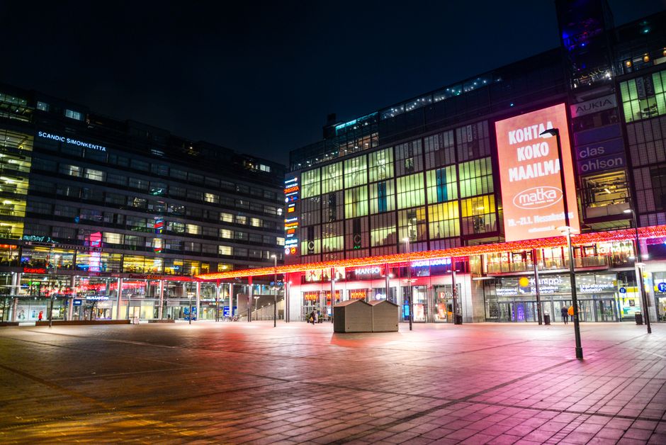 Illuminated city square at night showcasing modern architecture