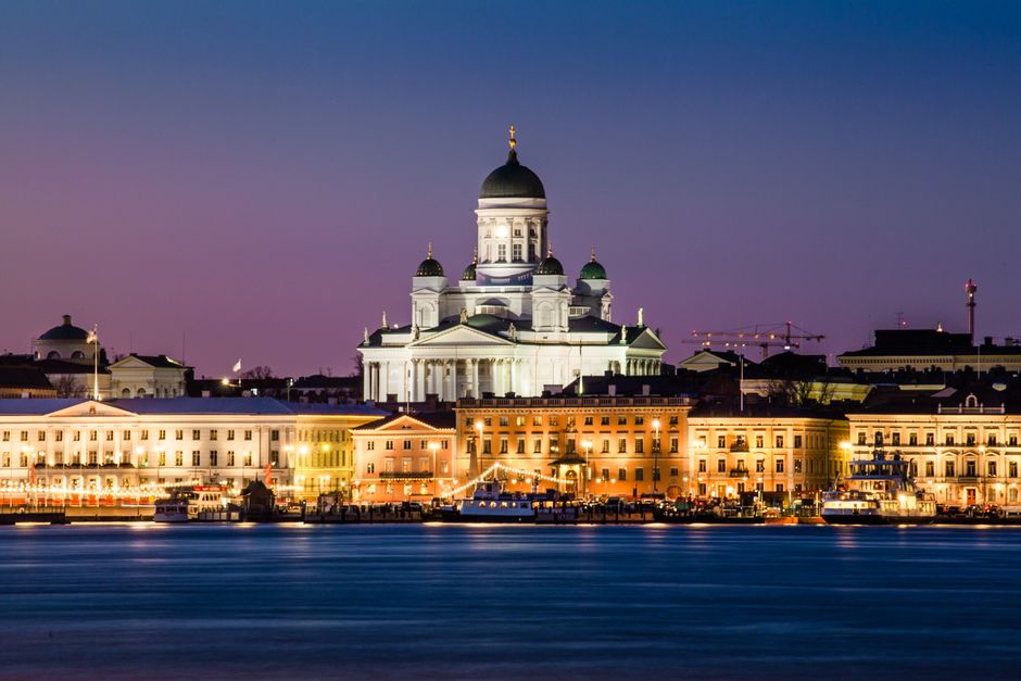 Helsinki Cathedral glowing at dusk with reflections on the water