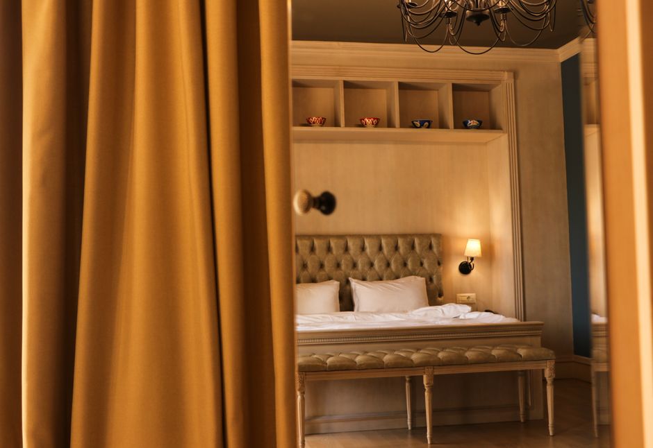 Elegant hotel room with stylish decor, plush bedding, and warm lighting